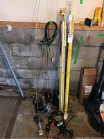 Overall view showing multiple whip and coil antennas next to yellow measuring rods and assorted cables