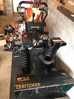 Front overall view showing housing, wheels, controls, and chute