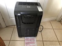 Front full view of the black Danby Premiere dehumidifier showing the water tank handle and unit's overall condition.