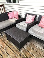 Overview showing two chairs, two-seat sofa, and storage bench on deck