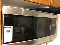 Front view of the stainless steel Frigidaire microwave oven showing the control panel and door.