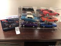 Full lot showing five model cars in clear plastic cases and the Monogram #3 Goodwrench Monte Carlo model kit box.