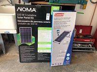 Two boxed crystalline solar panel kits side by side