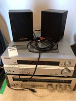 Front view of Pioneer VSX-515 receiver stacked on Sony STR-3800 receiver with Pioneer rear speakers on top and cables visible.