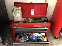 Side angled full view of the toolbox showing overall condition and contents in drawers and lid area.