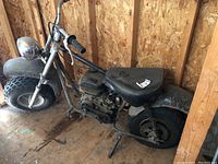 Full left side view of bike showing frame, tires, seat and engine