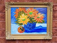 Full framed painting showing vibrant sunflowers in a blue vase with a red-orange fruit on table.