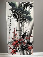 View of the entire Chinese watercolour painting showing bamboo, plum blossoms, artist calligraphy, and stamps.