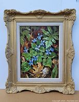 Frontal view of painting in ornate gilt wood frame