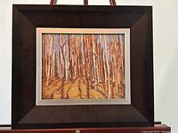 Full view of the framed art piece showing the birch trees and frame.