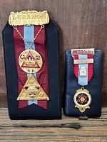 Two Lebanon Freemason medals displayed on black mounts, showing size difference and design detail
