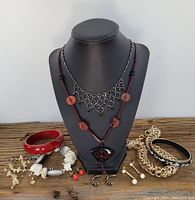 Full view of costume jewellery collection on display stand and wooden surface