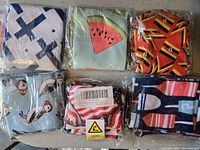 Six pairs of new unisex basketball socks in original packaging with distinct patterns as seen.