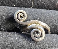 Close-up of the silver ring showing spiral design from the top edge.