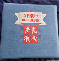 Blue Pro Card Album closed showing album front cover with logo and images of hockey players