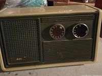 Front view of vintage Audition radio showing speaker grille, brand plate, and dual control knobs