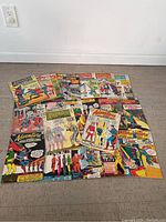 Full view of all 22 Adventure Comics spread on floor showing covers with Superboy and other heroes.