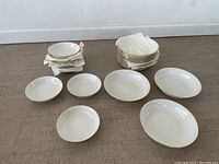 Full view of 24 Lenox Special Oxford China bowls arranged in two stacks and laid out showing sizes.