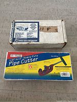 Boxes of the pipe cutters; one labeled Perfection Corporation and the other Central Heavy Duty Pipe Cutter.