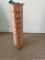 Front view of the vintage botanical plant themed gift wrap roll standing upright showing the full height and pattern of the paper.
