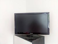 Front view of black Samsung 26 inch SyncMaster monitor on stand against white background.