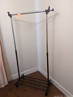 Full view of the light duty clothes rack showing metal frame and hanging bar.