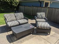 Overview of entire four-piece patio set on concrete patio
