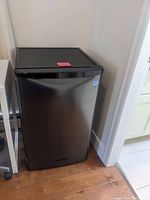 Front view of the small black Danby fridge showing its compact size and black finish.