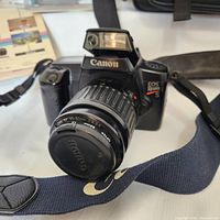 Photo of Canon EOS Rebel S 35mm SLR film camera with EF 35-80mm lens attached, showing front view including Canon logo and lens cap with filter.