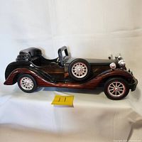 Side angle of the Heritage Mint Ltd. Road Classics wooden roadster model highlighting its two-tone wood finish and chrome accents.