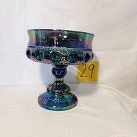 Front view of vintage Indiana Carnival Glass Kings Crown candy dish showing iridescent blue color, rounded bubble design on bowl exterior, and pedestal base.