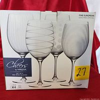 Box packaging showing Mikasa Cheers set of 4 lead-free crystal red wine glasses with different etched designs on each glass.