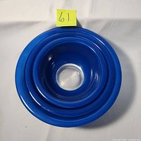 Top down photo showing the three blue Pyrex mixing bowls nested inside each other, highlighting the clear bottoms and the size differences.