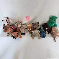 Full lot of 12 vintage Beanie Babies plush toys arranged in two rows, showing a variety of animal characters with tags attached.