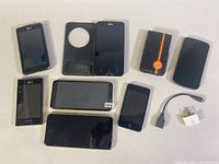 Photo showing multiple devices including LG cell phones, iPod touch, Samsung phone, accessories
