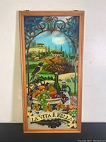 Front view of the stained glass panel depicting vineyard and fruit scene with 'La Vita e Bella' banner.