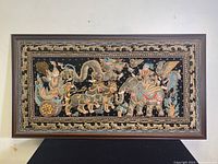 Full view of the framed tapestry showing the entire artwork and frame.