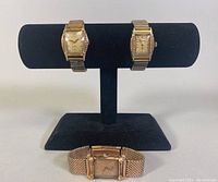 Three vintage ladies Bulova watches on display stand showing overall condition and band types