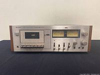 Front view of the Sony TC-206SD cassette deck showing cassette slot, VU meters, and control buttons.