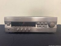 Front view of Yamaha RX-396 stereo receiver showing knobs, buttons, display and tuning dial.
