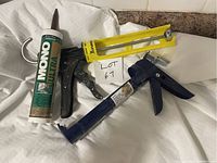 Photo showing two caulking guns and one tube of MONO Ultra exterior caulk with lot label