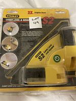 Front view of Stanley S2 Laser Level and Square in sealed blister packaging showing yellow laser level device.