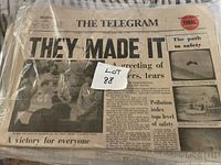 Front page of The Telegram newspaper showing headline "THEY MADE IT" with date April 17, 1970 visible, packaged in plastic wrap with label Lot 88.