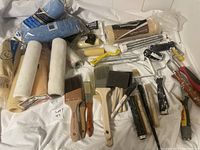 Wide view showing the entire lot including brushes, rollers, foam applicators, and roller refills