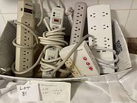 Photo displaying all four power bars laid inside a box with cords wrapped around them, showing varying lengths and styles.
