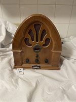 Front view of vintage Prosonic PQR-138 radio showing wooden casing, speaker grill, and control knobs.