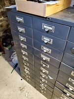 Front corner view showing three columns of drawers, label holders on each drawer