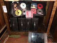 Photo shows black CD cases with multiple CDs inside, some discs and their covers are visible such as Billy Joel and Melissa Etheridge.