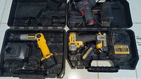 Top view of three cordless power tools in their carrying cases showing DeWalt yellow and black power tools and Bosch black and red tool.