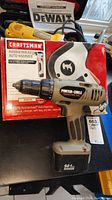 Porter Cable cordless drill in front of Craftsman Hammerhead auto hammer box, showing drill angle and battery pack.